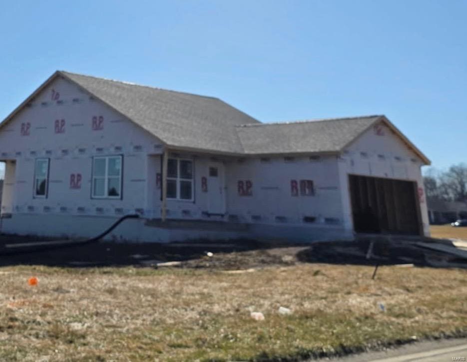 unfinished property featuring a garage