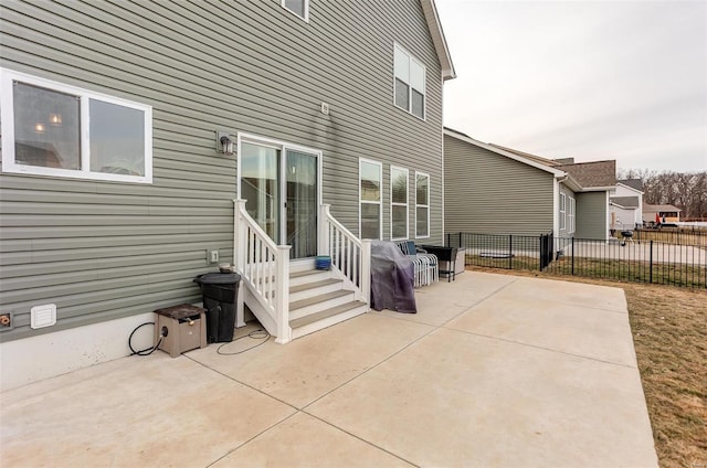 view of patio featuring entry steps and fence