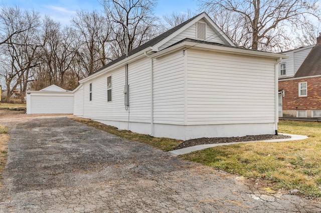 view of side of home with an outbuilding and a detached garage