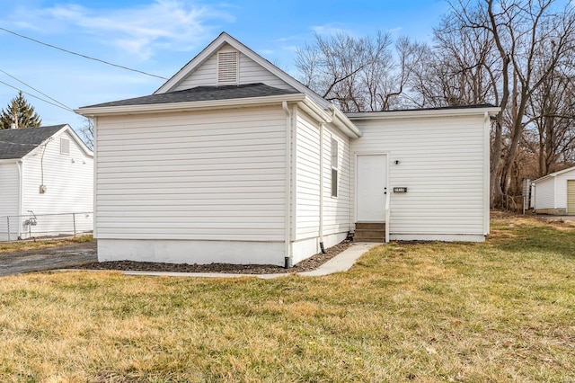 exterior space featuring entry steps and a lawn