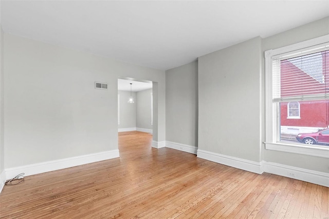 spare room featuring light hardwood / wood-style flooring and plenty of natural light