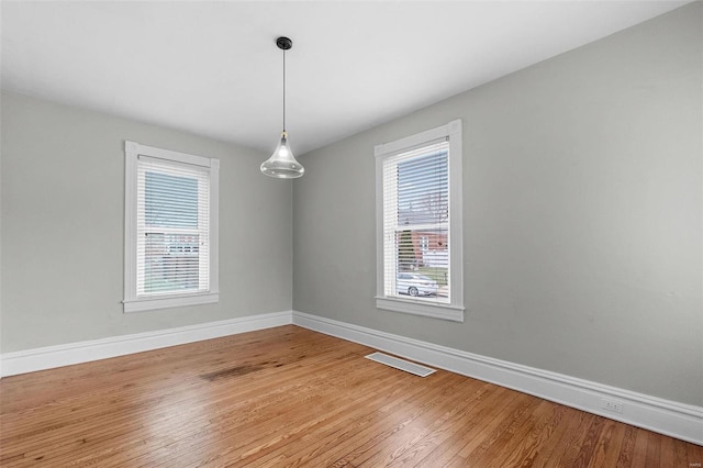 unfurnished room with hardwood / wood-style floors