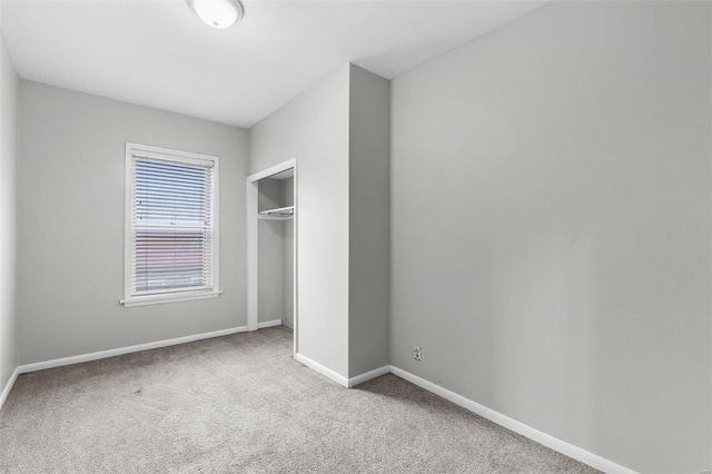 unfurnished bedroom with carpet floors and a closet