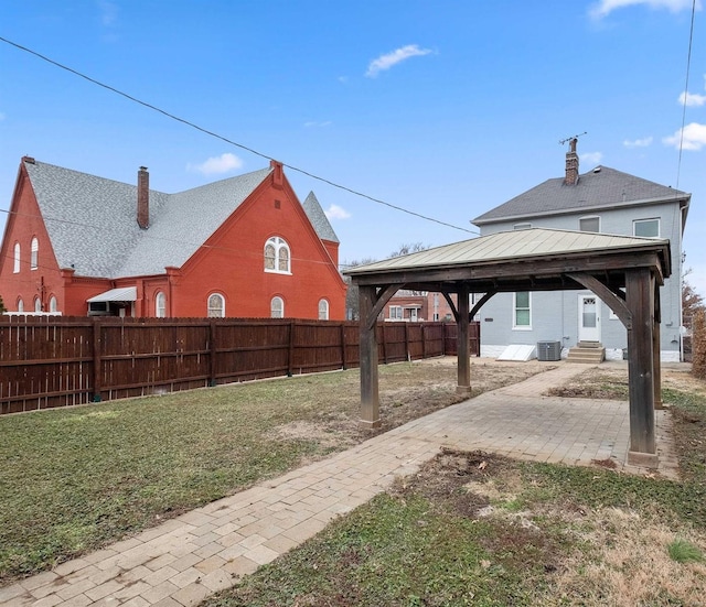 view of yard featuring a gazebo, central AC, and a patio area