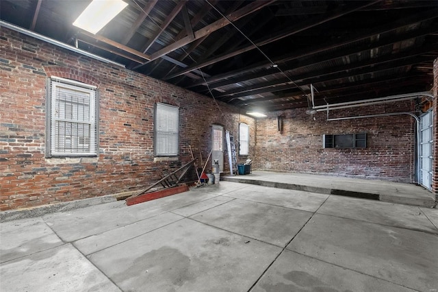 interior space with brick wall and concrete flooring