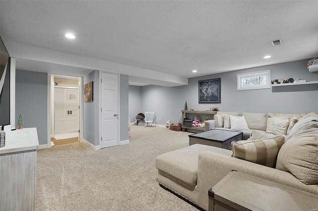 living area featuring a textured ceiling, baseboards, visible vents, and light colored carpet