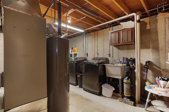 unfinished basement with a sink, washing machine and dryer, and gas water heater