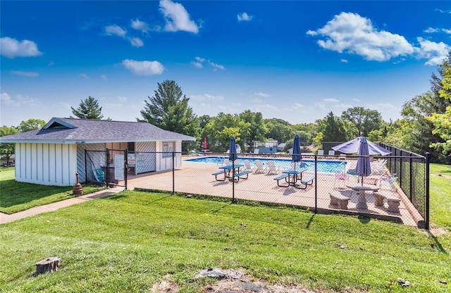 pool featuring fence, a patio, and a lawn