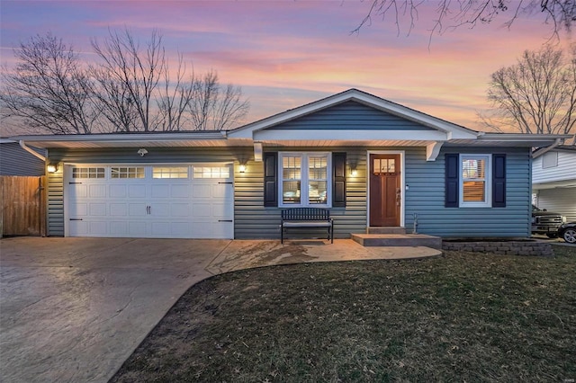 view of front of property with a garage, fence, a front lawn, and concrete driveway