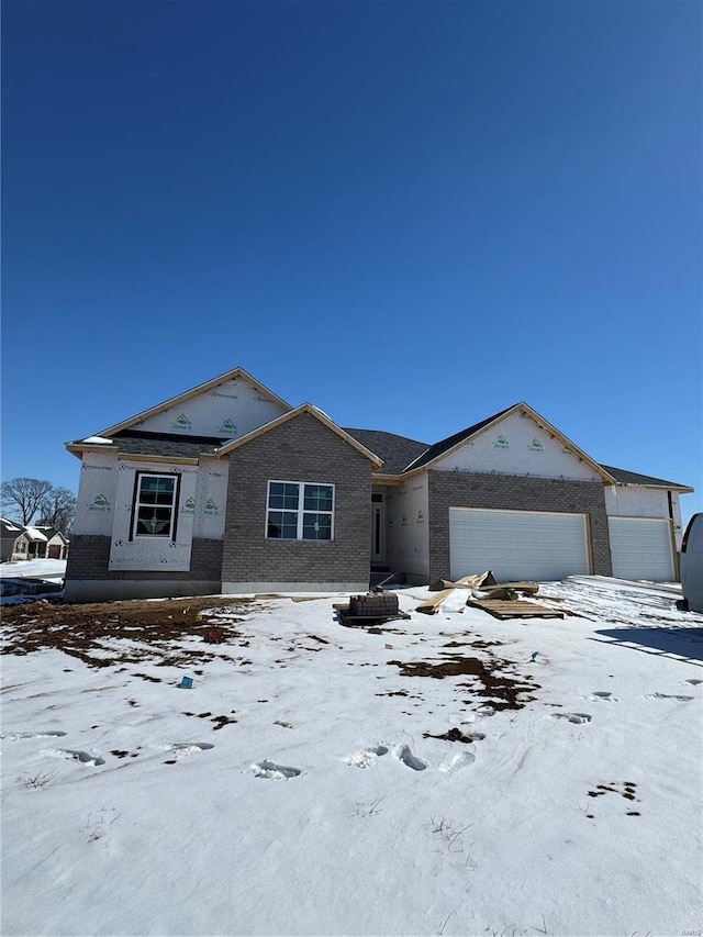 view of front of home featuring a garage and brick siding