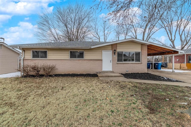 view of front of property with a carport and a front lawn