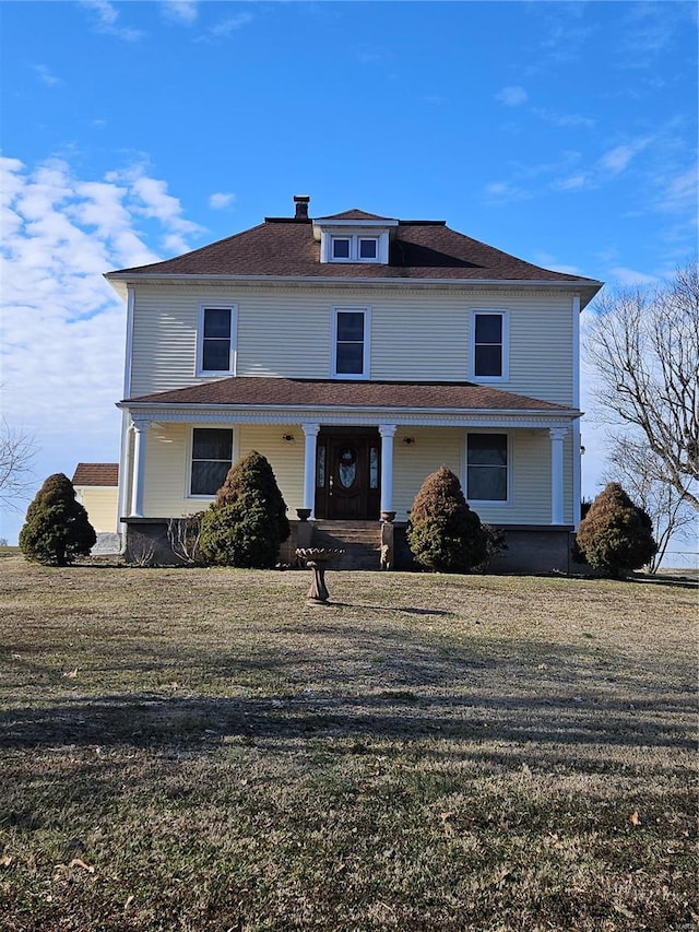 front of property featuring a porch and a front lawn