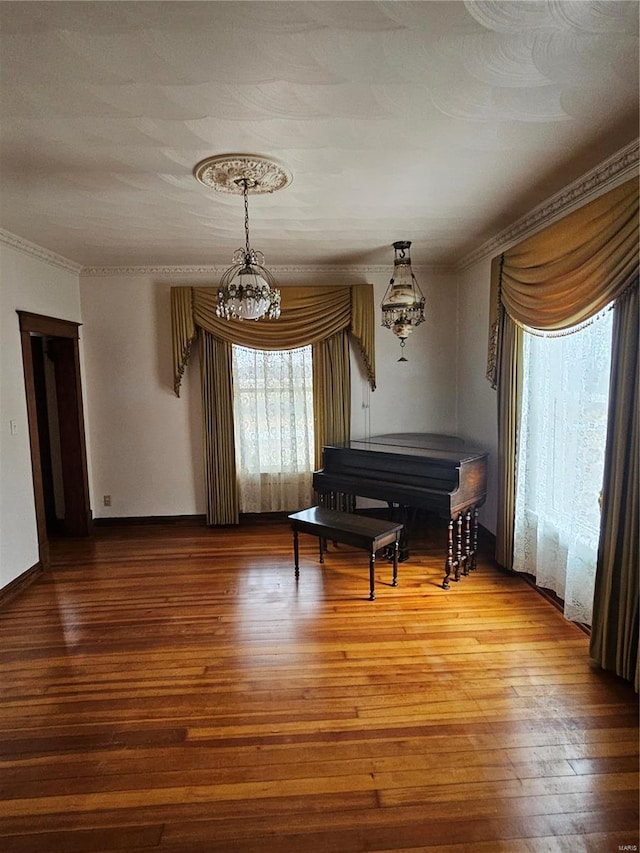 living area with crown molding and wood-type flooring