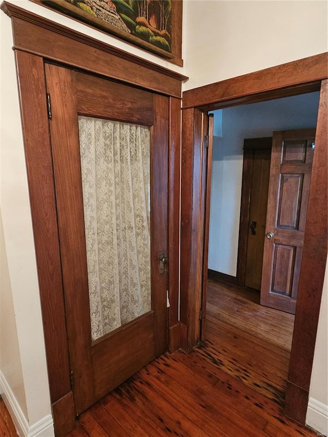 hallway with dark wood-type flooring