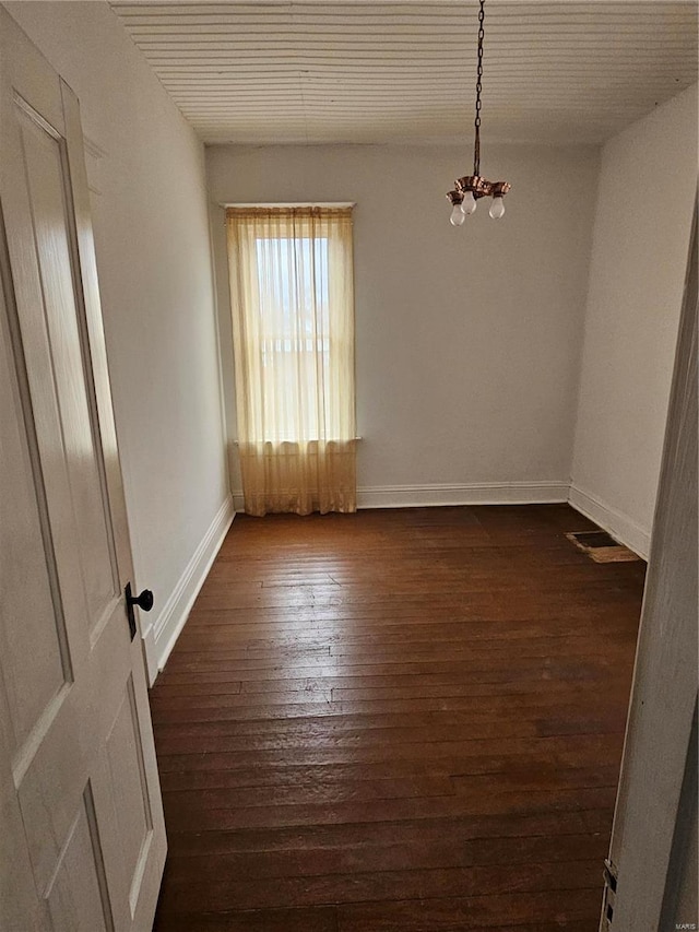 unfurnished room featuring dark wood-type flooring