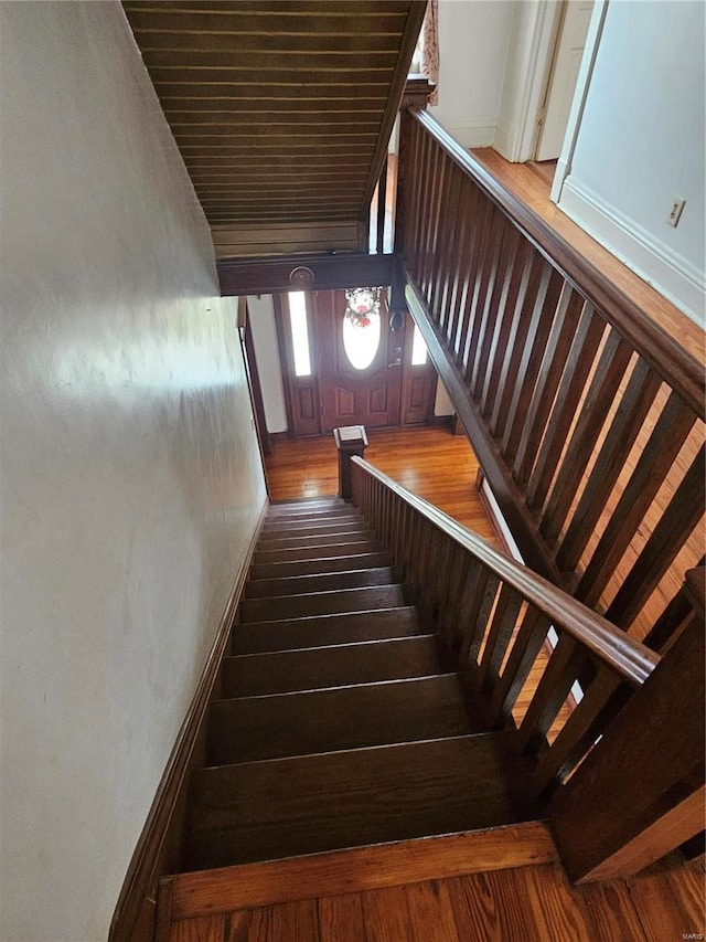 stairs featuring wood-type flooring