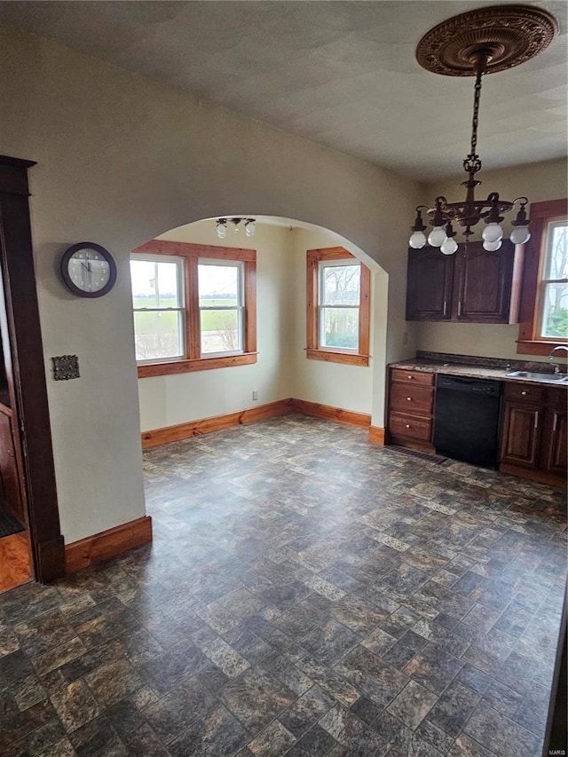 kitchen with dark brown cabinetry, black dishwasher, sink, and plenty of natural light