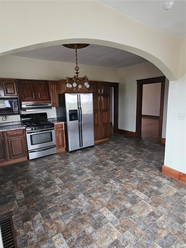 kitchen with stainless steel appliances and dark brown cabinetry