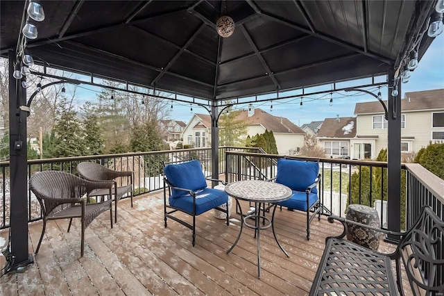 wooden terrace with a gazebo and a residential view