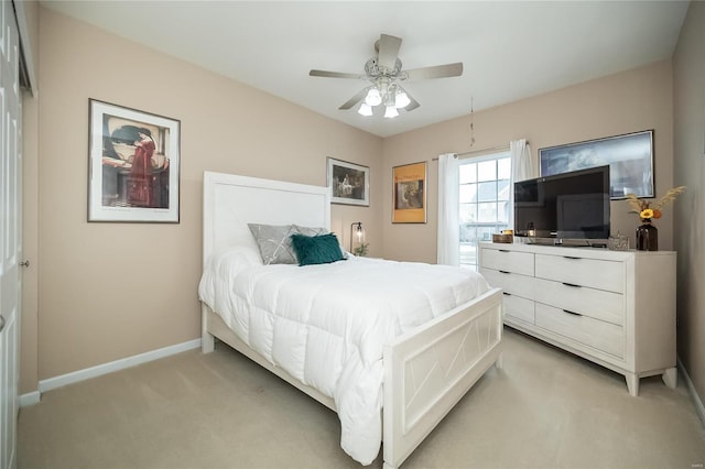 bedroom with baseboards, ceiling fan, and light colored carpet