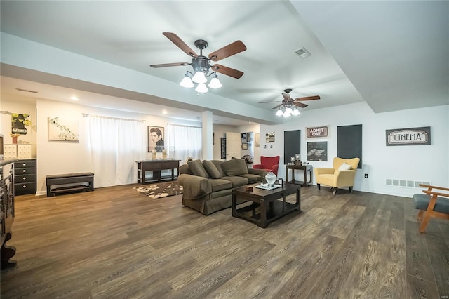 living room with dark wood-style floors and visible vents