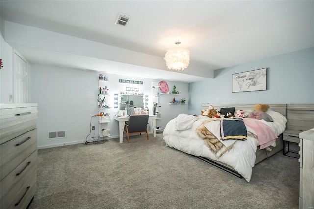 carpeted bedroom with a notable chandelier, visible vents, and baseboards