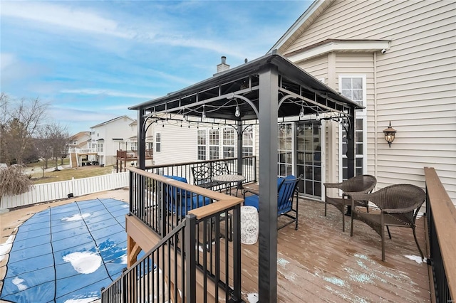 wooden terrace featuring a gazebo