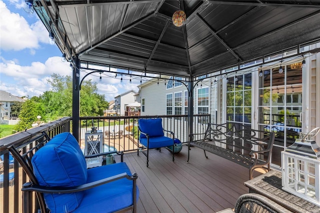 wooden terrace featuring a gazebo