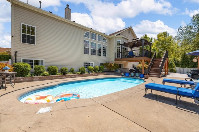 pool with stairs, fence, a patio, and a gazebo