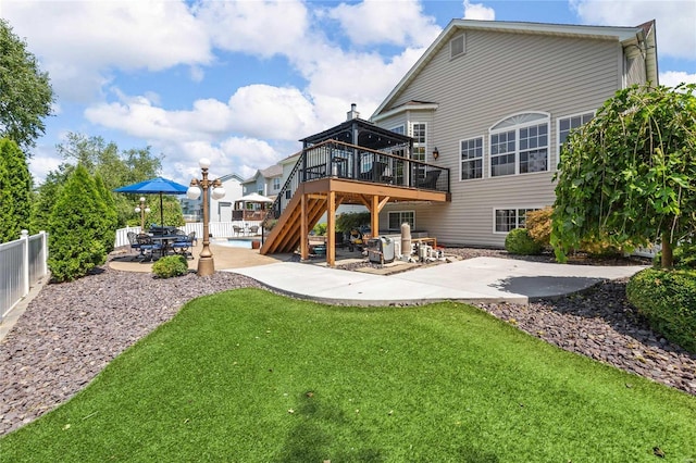 back of property featuring stairs, a patio, a deck, and fence