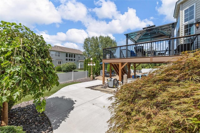 view of patio with fence and a wooden deck