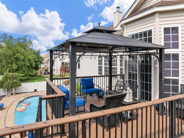 deck with an outdoor pool and a gazebo