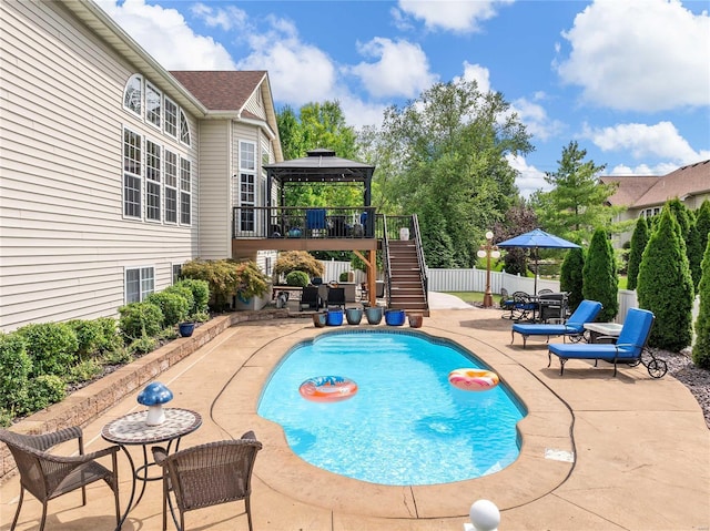 view of swimming pool featuring a fenced in pool, a patio, a gazebo, fence, and stairs