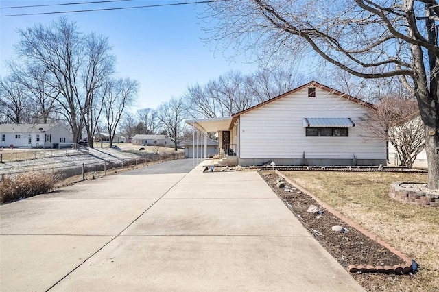 view of property exterior with a lawn and a carport