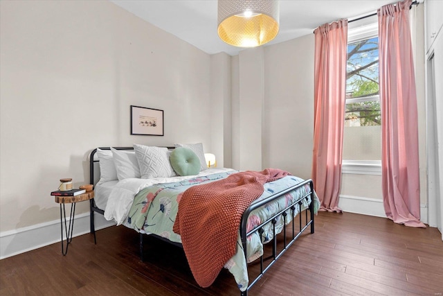 bedroom featuring baseboards and hardwood / wood-style floors