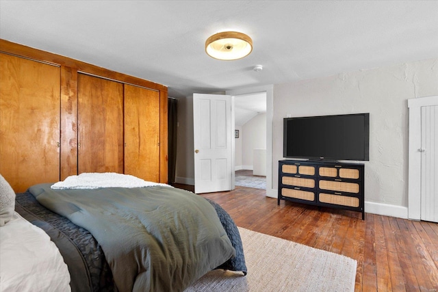 bedroom with baseboards and wood-type flooring