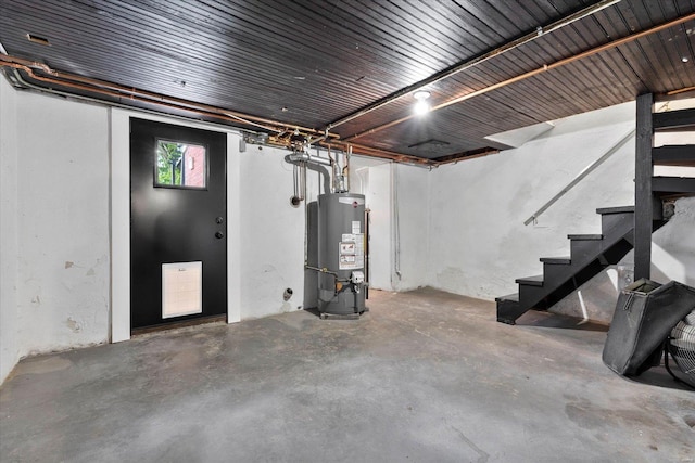 below grade area with stairs and gas water heater