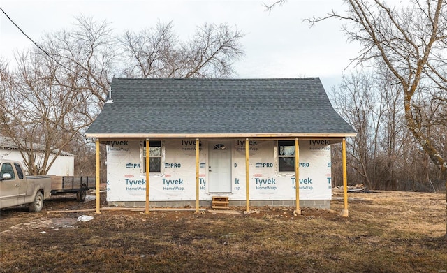 view of front of home with a shingled roof and a porch