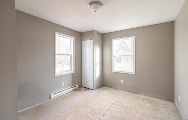 interior space featuring a baseboard heating unit and a closet