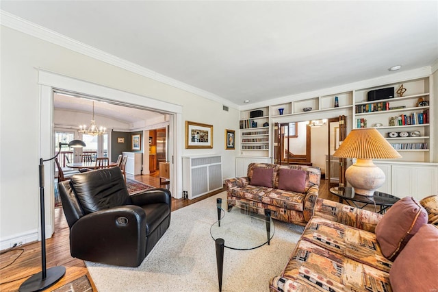 living room featuring radiator, a chandelier, wood finished floors, and built in features