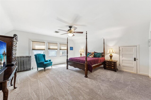 bedroom with visible vents, radiator heating unit, ceiling fan, carpet, and vaulted ceiling