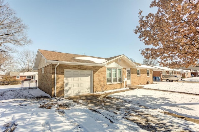 single story home featuring a garage, fence, and brick siding