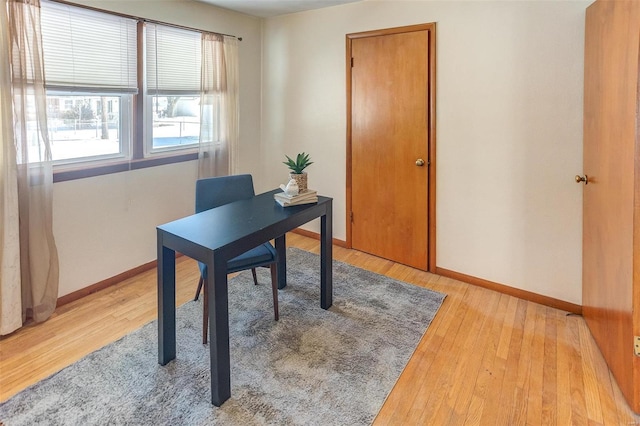 office space with light wood-style flooring and baseboards