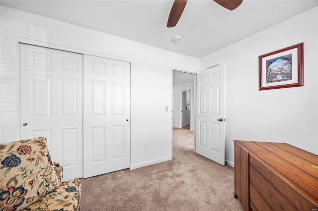 sitting room with light carpet, ceiling fan, visible vents, and baseboards