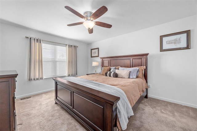 bedroom with visible vents, baseboards, ceiling fan, and light colored carpet