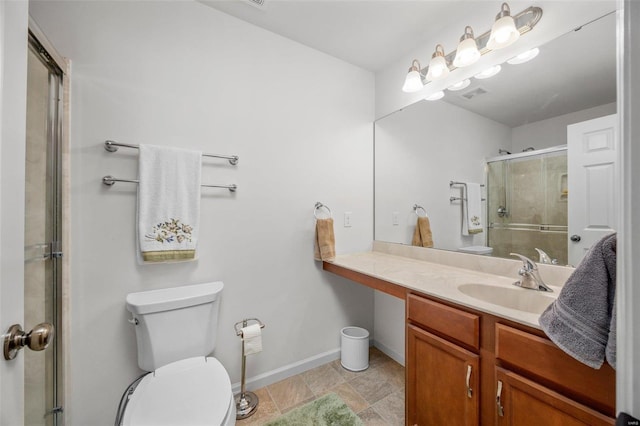 bathroom featuring toilet, visible vents, vanity, baseboards, and a shower stall