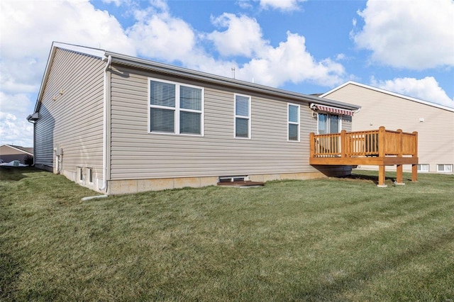 rear view of property featuring a yard and a deck