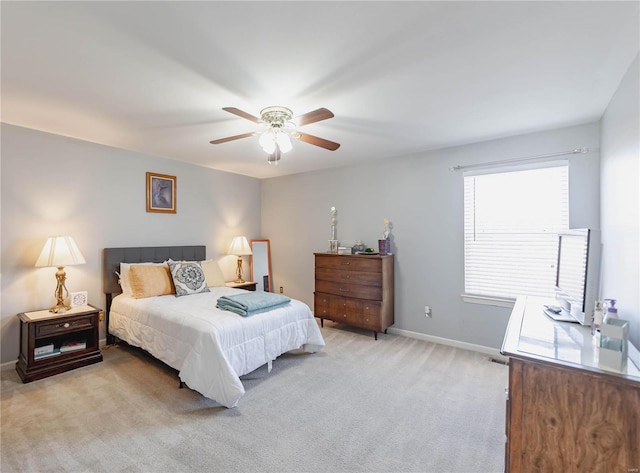 bedroom featuring light carpet, ceiling fan, and baseboards