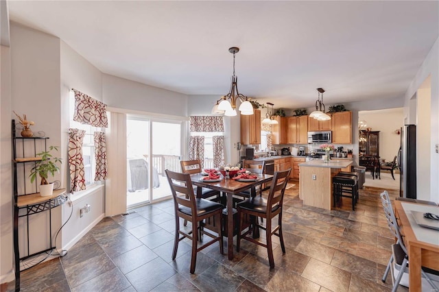 dining area with stone finish floor and baseboards