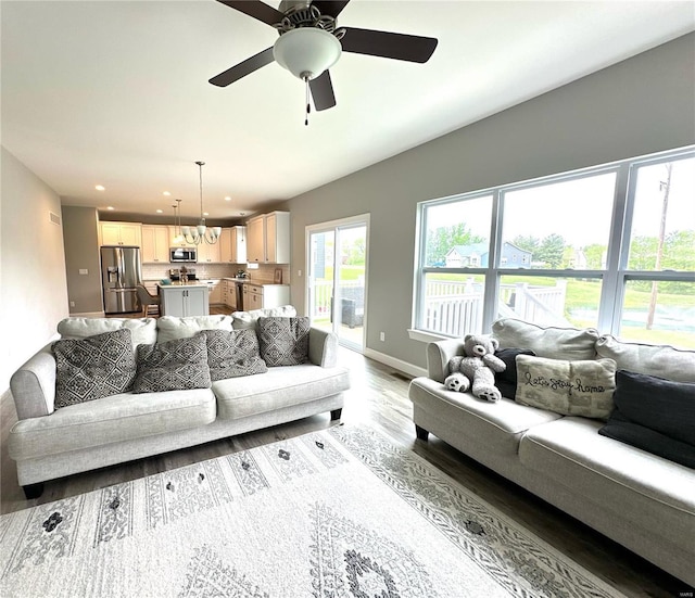 living room featuring recessed lighting, a ceiling fan, baseboards, and wood finished floors